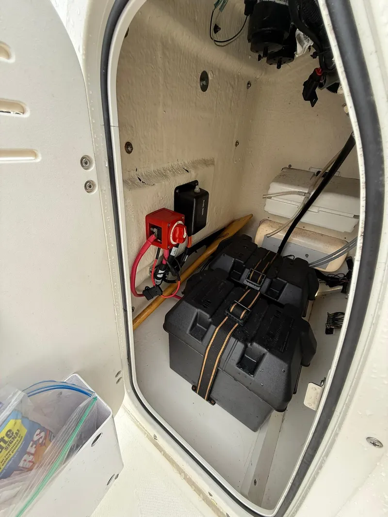 Slide: The Image of 2019 Boston Whaler 150 Montauk interior storage with battery and wiring. - 11