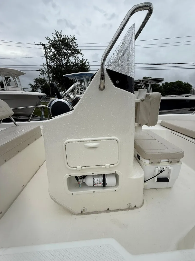Slide: The Image of 2019 Boston Whaler 150 Montauk boat console with storage and fire extinguisher. - 4