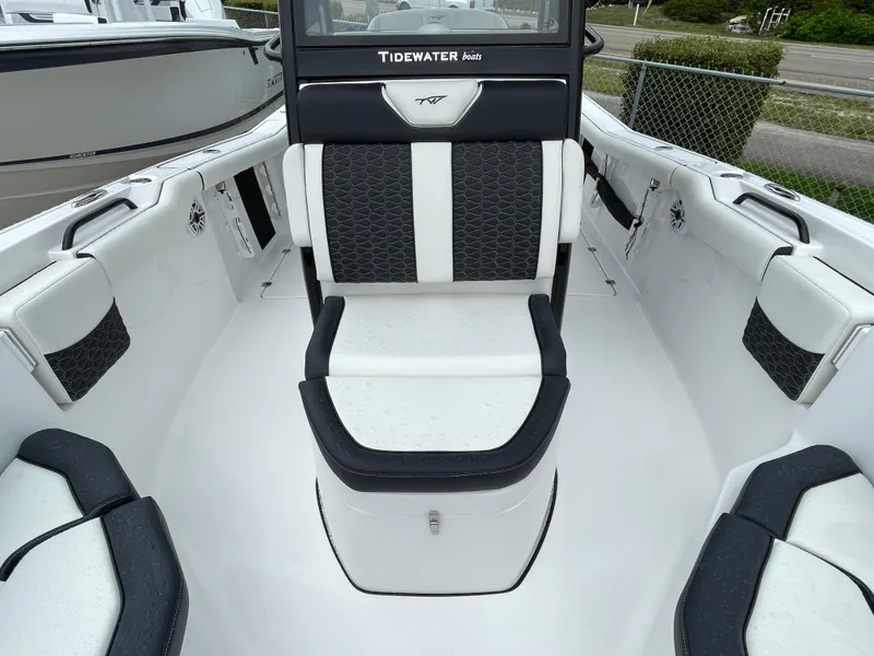Slide: The Image of 2026 Tidewater 256 CC Adventure boat interior with black and white seating. - 10