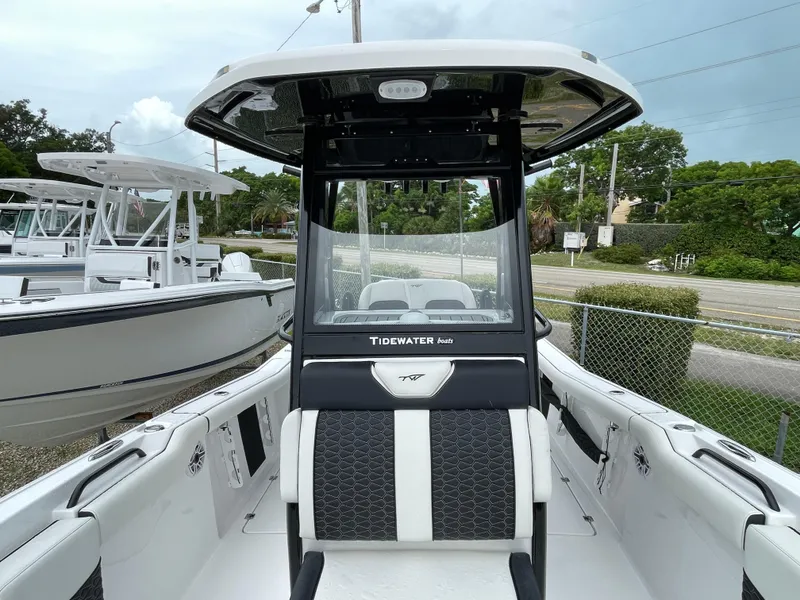 Slide: The Image of 2026 Tidewater 256 CC Adventure boat, sleek design, white and black interior, outdoor display. - 11