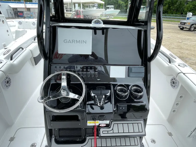 Slide: The Image of 2026 Tidewater 256 CC Adventure boat dashboard with Garmin navigation system. - 14