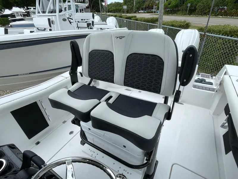 Slide: The Image of 2026 Tidewater 256 CC Adventure boat with dual helm seats and modern design. - 16