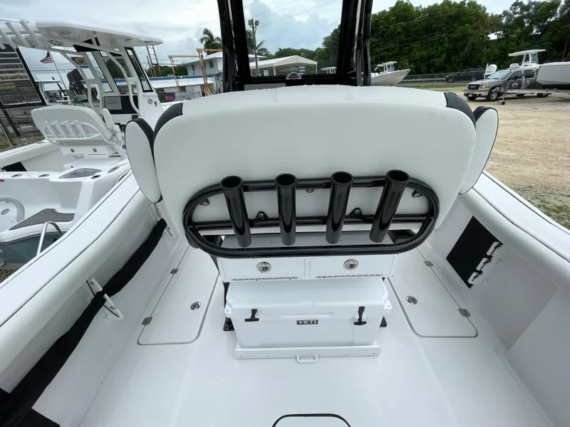 Slide: The Image of 2026 Tidewater 256 CC Adventure boat interior with rod holders and seating. - 17