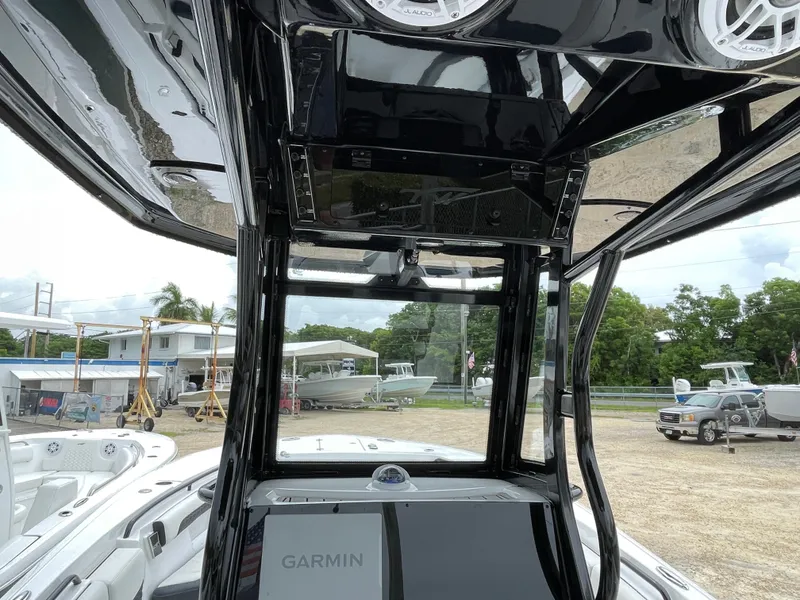 Slide: The Image of 2026 Tidewater 256 CC Adventure boat interior with Garmin electronics and sleek black design. - 18