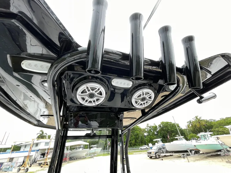 Slide: The Image of Tidewater 256 CC Adventure 2026 boat with rod holders and speakers, docked outdoors. - 19