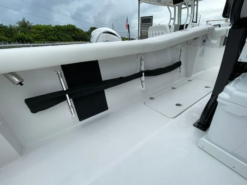 Slide: The Image of 2026 Tidewater 256 CC Adventure boat interior with rod holders and storage compartments. - 28