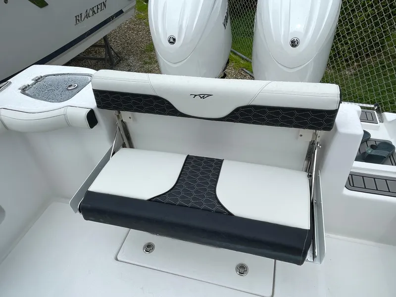 Slide: The Image of 2026 Tidewater 256 CC Adventure boat seat with black and white upholstery. - 29
