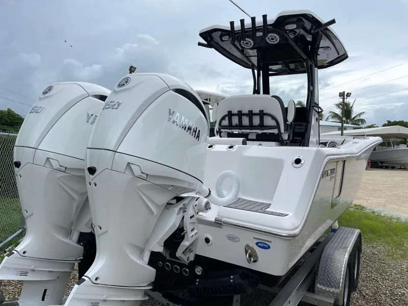 Slide: The Image of 2026 Tidewater 256 CC Adventure boat with dual Yamaha engines on a trailer. - 33