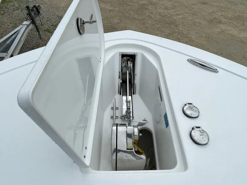 Slide: The Image of Open anchor compartment on 2026 Tidewater 256 CC Adventure boat, showcasing anchor mechanism. - 4