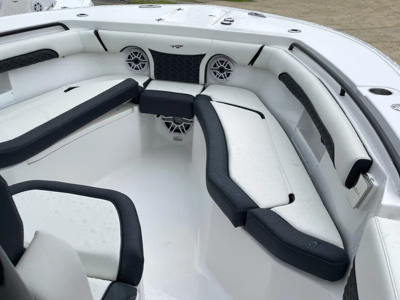 Slide: The Image of 2026 Tidewater 256 CC Adventure boat interior with cushioned seating and speakers. - 5