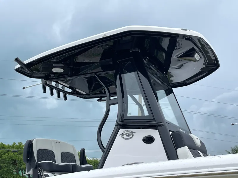 Slide: The Image of 2026 Tidewater 256 CC Adventure boat, featuring sleek black and white design under cloudy skies. - 9