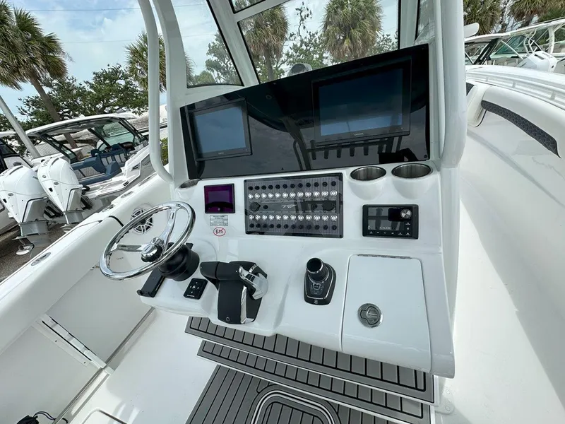 Slide: The Image of 2025 Tidewater 320 CC Adventure boat interior with rod holders and storage compartments. - 10