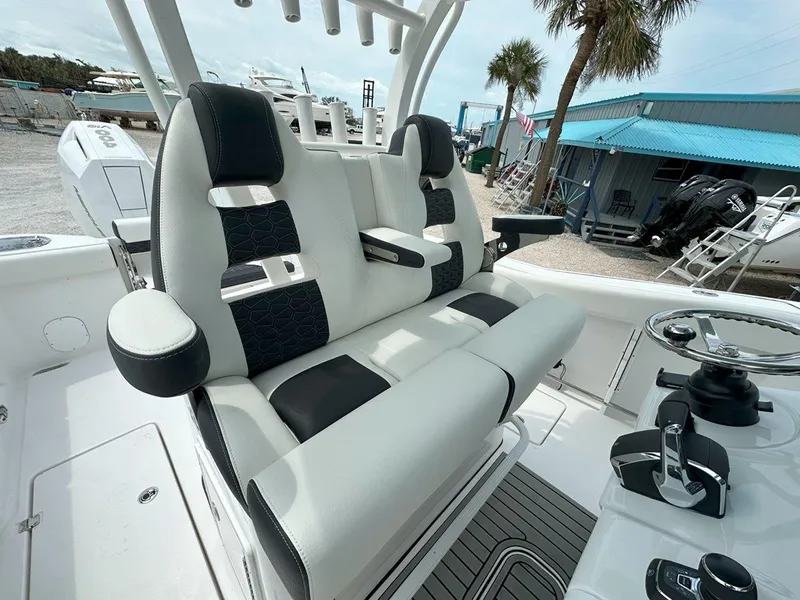 Slide: The Image of 2025 Tidewater 320 CC Adventure boat interior with storage compartments and seating. - 11