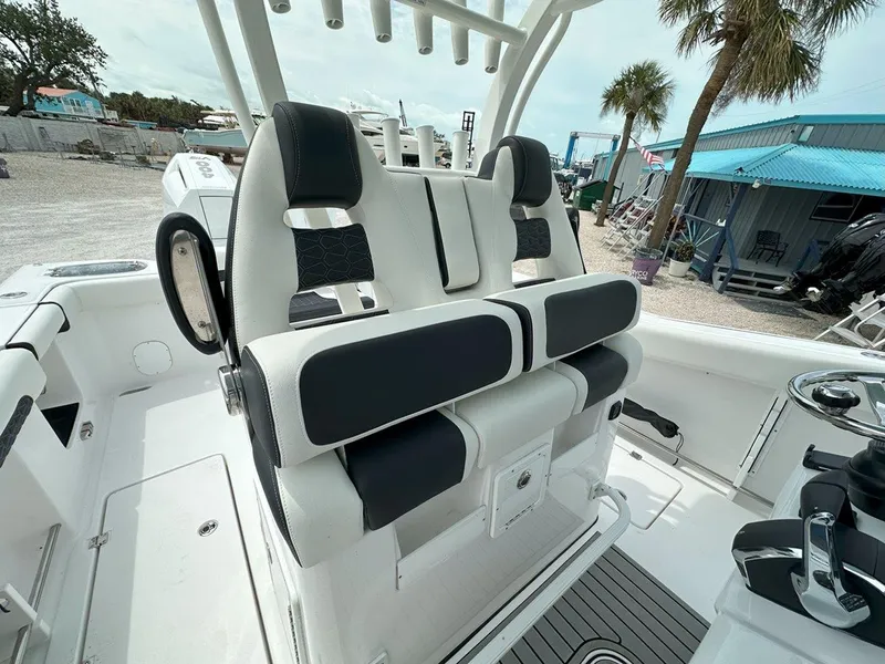 Slide: The Image of 2025 Tidewater 320 CC Adventure boat interior with dual seating and Yamaha engine. - 12
