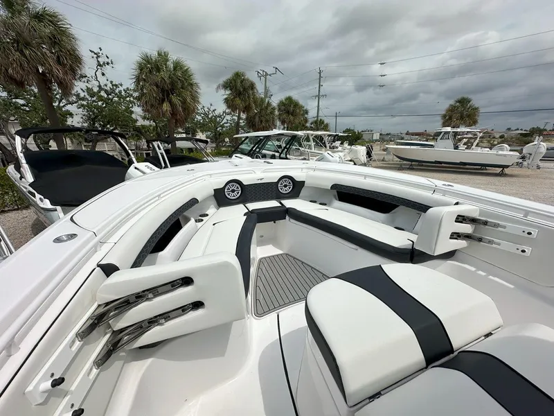 Slide: The Image of Tidewater 320 CC Adventure 2025 boat speakers and rod holders under blue canopy. - 14