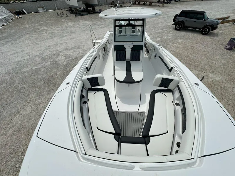 Slide: The Image of 2025 Tidewater 320 CC Adventure boat interior with seating and storage features. - 16