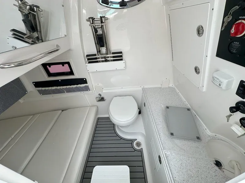 Slide: The Image of 2025 Tidewater 320 CC Adventure boat dashboard with Garmin displays and Mercury controls. - 17