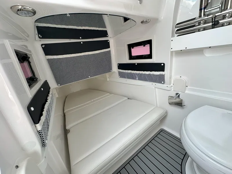 Slide: The Image of Steering wheel of 2025 Tidewater 320 CC Adventure boat, featuring modern controls. - 18