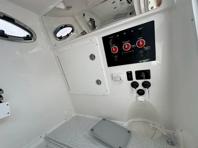 Slide: The Image of Control panel of 2025 Tidewater 320 CC Adventure boat with various switches and buttons. - 19