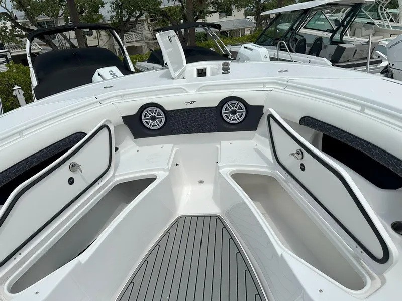 Slide: The Image of Control panel of 2025 Tidewater 320 CC Adventure boat, featuring joystick and storage compartment. - 20