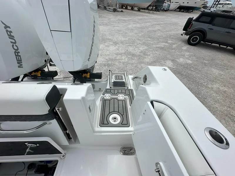 Slide: The Image of 2025 Tidewater 320 CC Adventure cabin interior with oval windows and stainless steel fittings. - 29