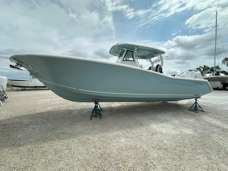 Slide: The Image of 2025 Tidewater 320 CC Adventure boat storage compartment with open hatch. - 33