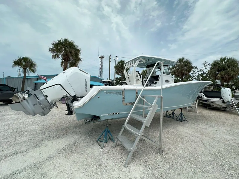 Slide: The Image of 2025 Tidewater 320 CC Adventure boat interior with seating, docked at a marina. - 35