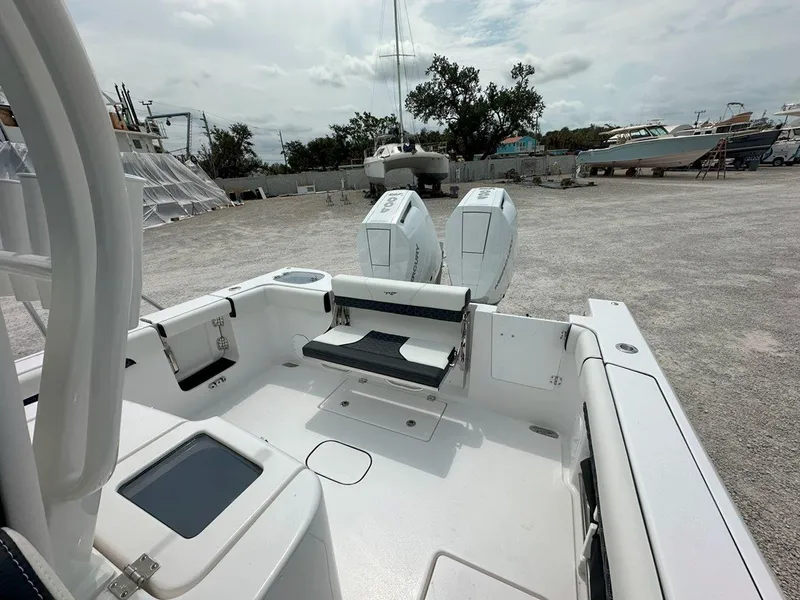 Slide: The Image of 2025 Tidewater 320 CC Adventure boat with Mercury engine under cloudy sky. - 6