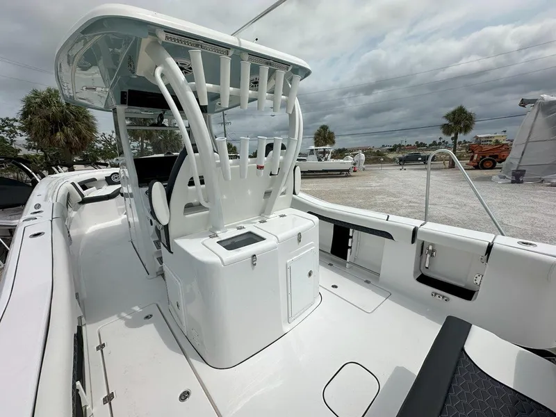 Slide: The Image of 2025 Tidewater 320 CC Adventure boat with extended swim ladder and dual outboard motors. - 7