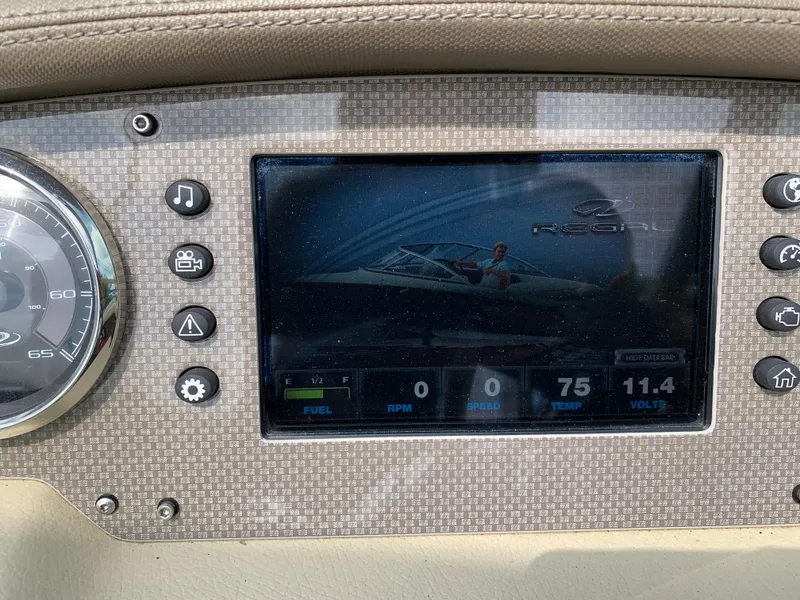 Slide: The Image of Dashboard of a 2014 Regal 27 FasDeck boat with digital display and controls. - 10