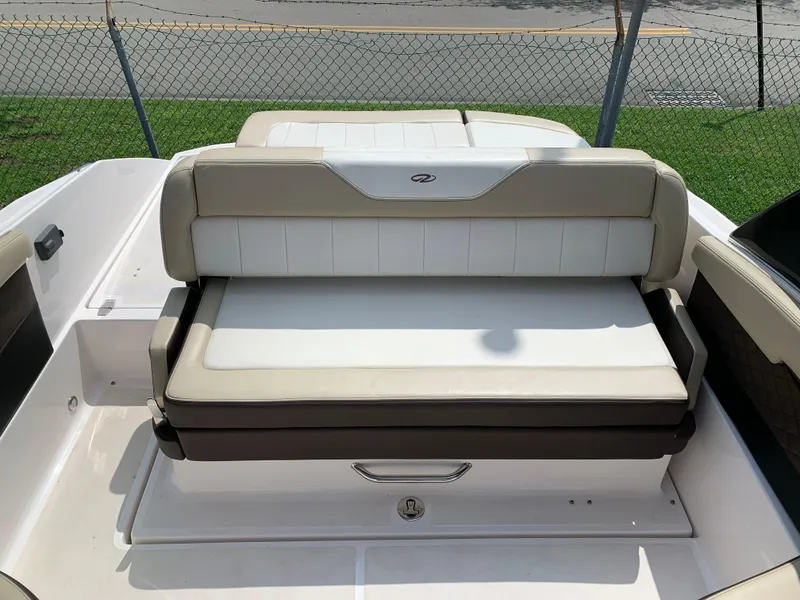 Slide: The Image of 2014 Regal 27 FasDeck boat seating area with beige and white upholstery. - 12