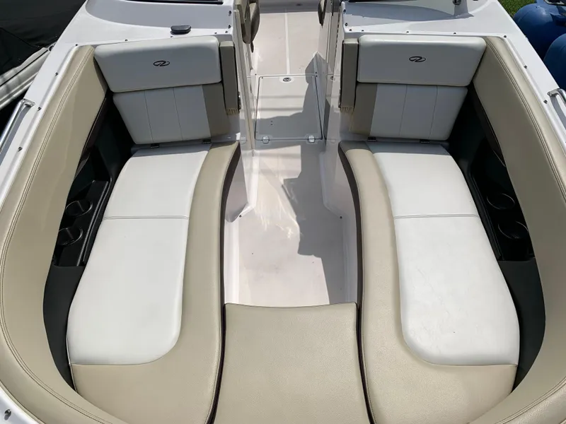 Slide: The Image of 2014 Regal 27 FasDeck boat interior with beige and white seating. - 2
