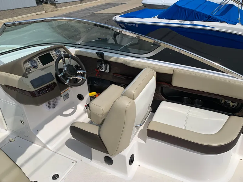 Slide: The Image of 2014 Regal 27 FasDeck boat interior with beige seating and modern dashboard. - 6