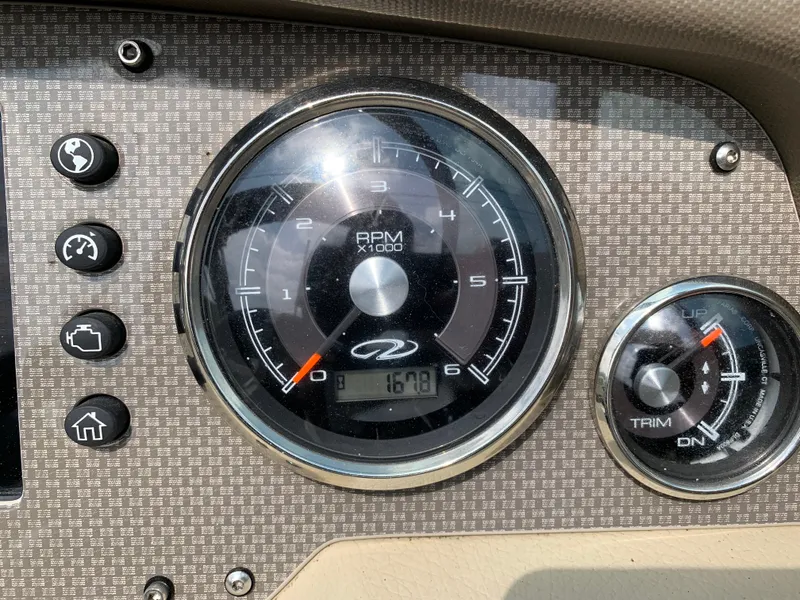 Slide: The Image of Dashboard of a 2014 Regal 27 FasDeck boat showing RPM and trim gauges. - 9