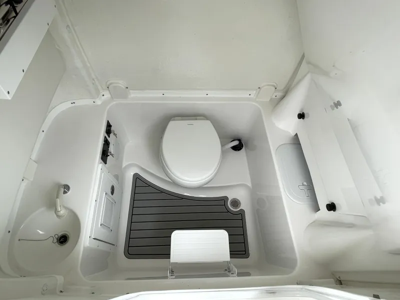 Slide: The Image of 2026 Tidewater 282 CC Adventure boat bathroom interior with toilet and sink. - 11