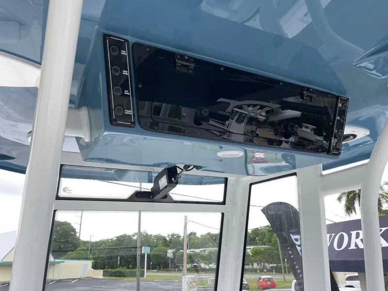 Slide: The Image of 2026 Tidewater 282 CC Adventure boat console with control panel and overhead electronics. - 14