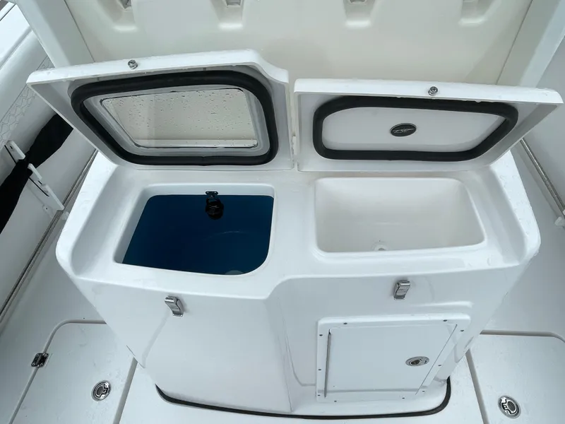 Slide: The Image of 2026 Tidewater 282 CC Adventure boat storage compartments, open with visible interior. - 20