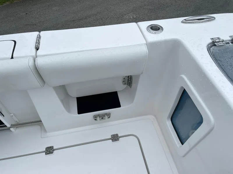 Slide: The Image of 2026 Tidewater 282 CC Adventure boat interior with storage compartments and seating. - 24