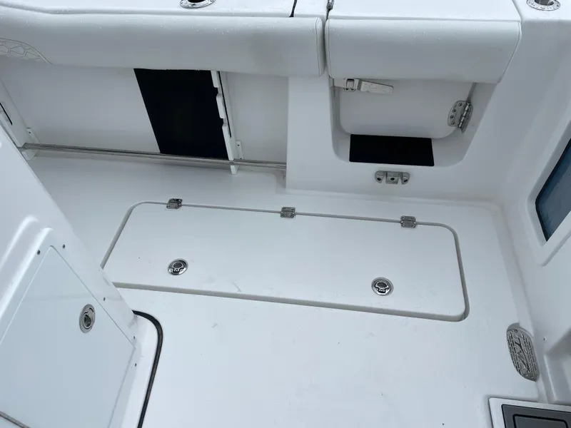 Slide: The Image of 2026 Tidewater 282 CC Adventure boat interior, featuring storage compartments and sleek white design. - 29