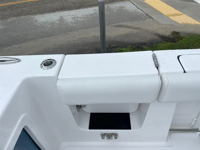 Slide: The Image of Tidewater 282 CC Adventure 2026 boat interior with white seating and storage compartment. - 30