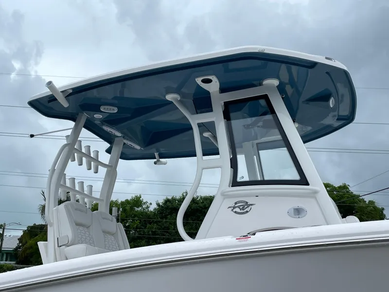 Slide: The Image of 2026 Tidewater 282 CC Adventure boat with sleek T-top design against cloudy sky. - 34