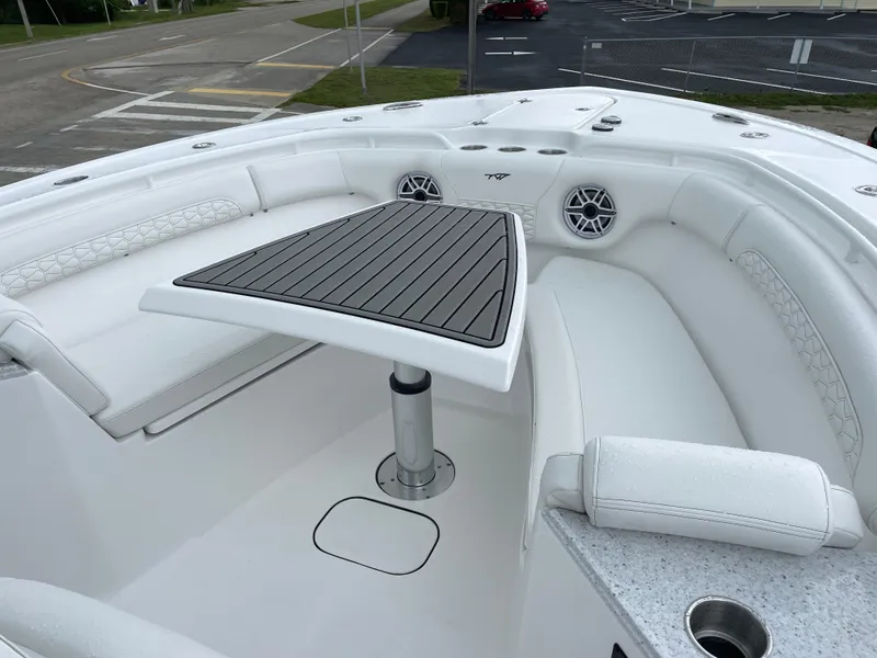 Slide: The Image of 2026 Tidewater 282 CC Adventure boat interior with white seating and a central table. - 7
