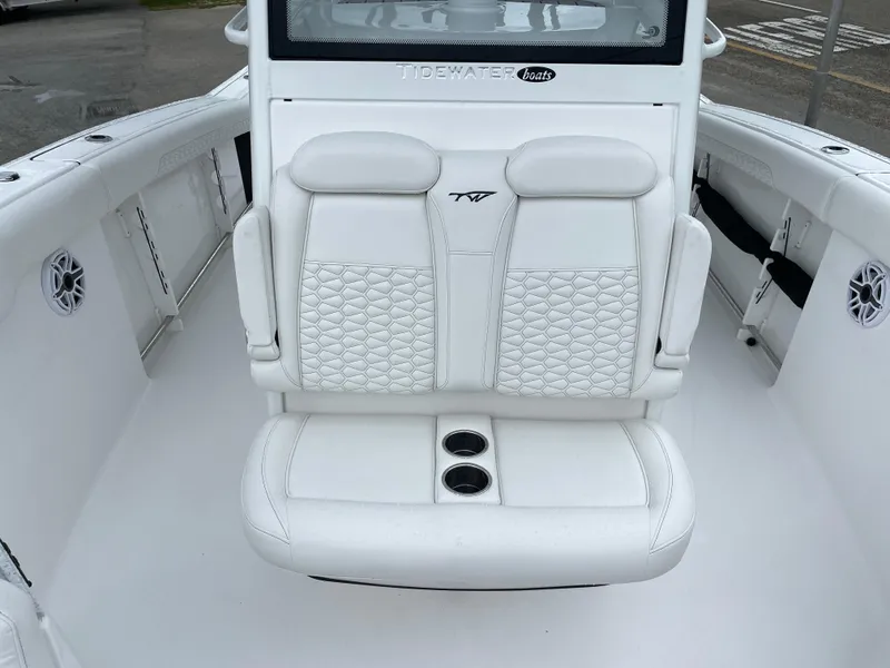 Slide: The Image of 2026 Tidewater 282 CC Adventure boat with white cushioned seating and cup holders. - 8