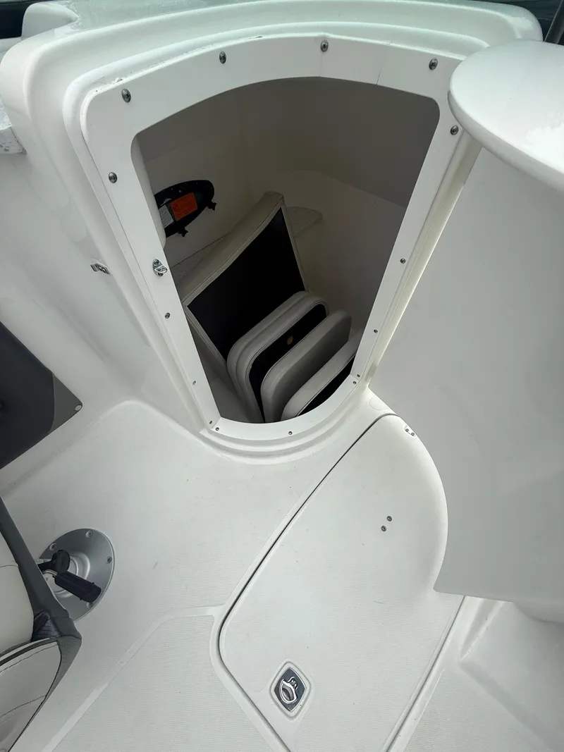 Slide: The Image of 2022 Hurricane SD 2486 boat storage compartment with white interior and seating. - 11