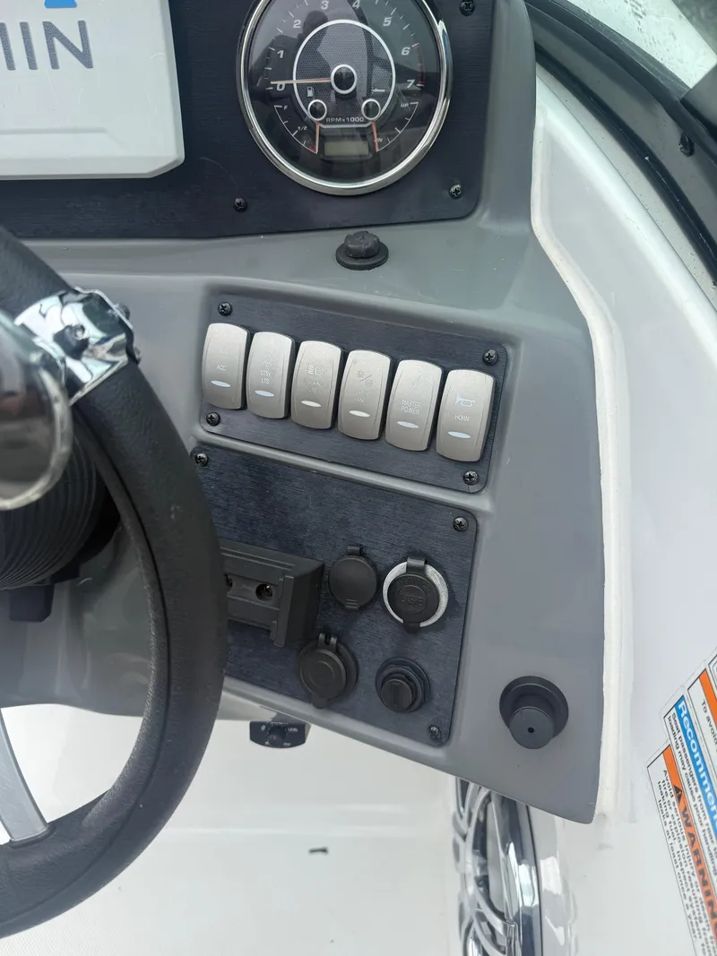 Slide: The Image of Control panel of 2022 Hurricane SD 2486 boat with steering wheel and switches. - 16