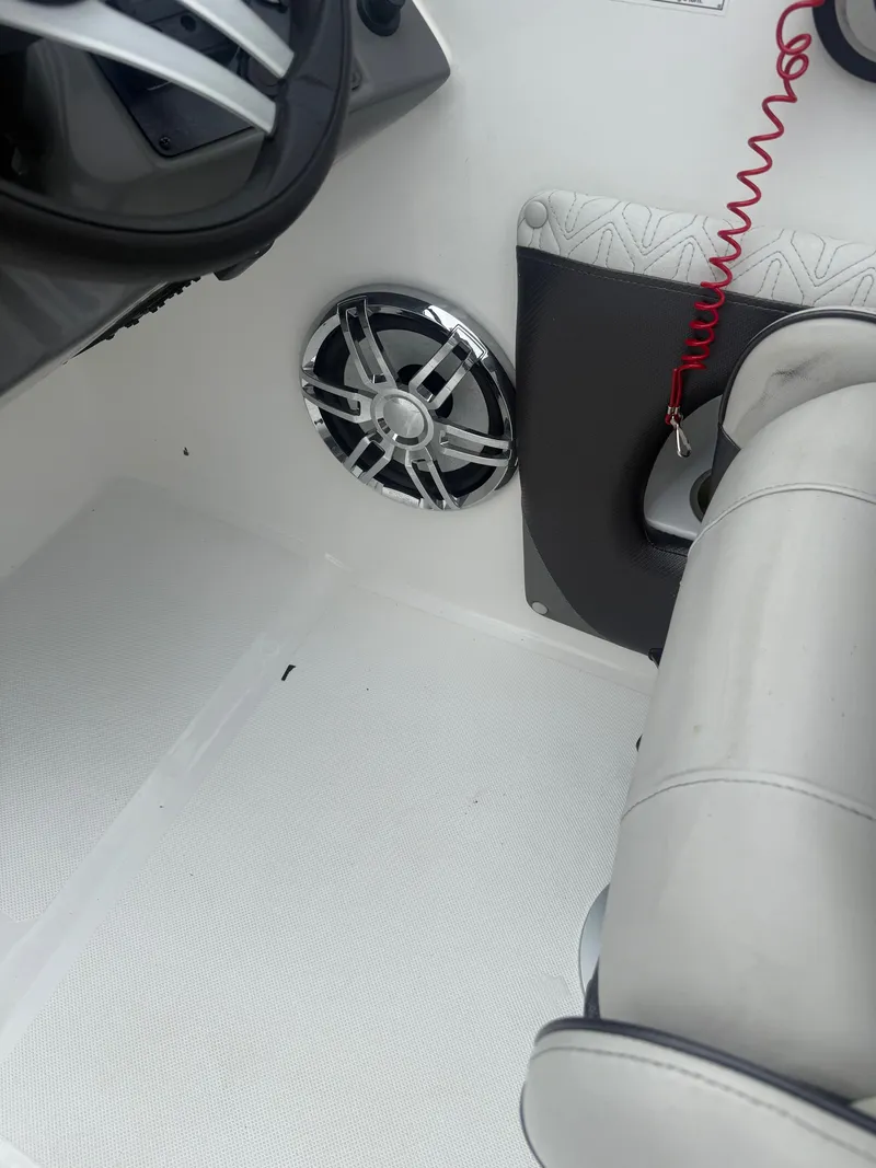 Slide: The Image of Interior of a 2022 Hurricane SD 2486 boat, featuring a speaker and seating area. - 18