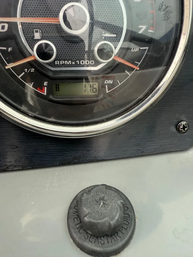 Slide: The Image of Close-up of a 2022 Hurricane SD 2486 boat dashboard gauge showing RPM and fuel levels. - 27
