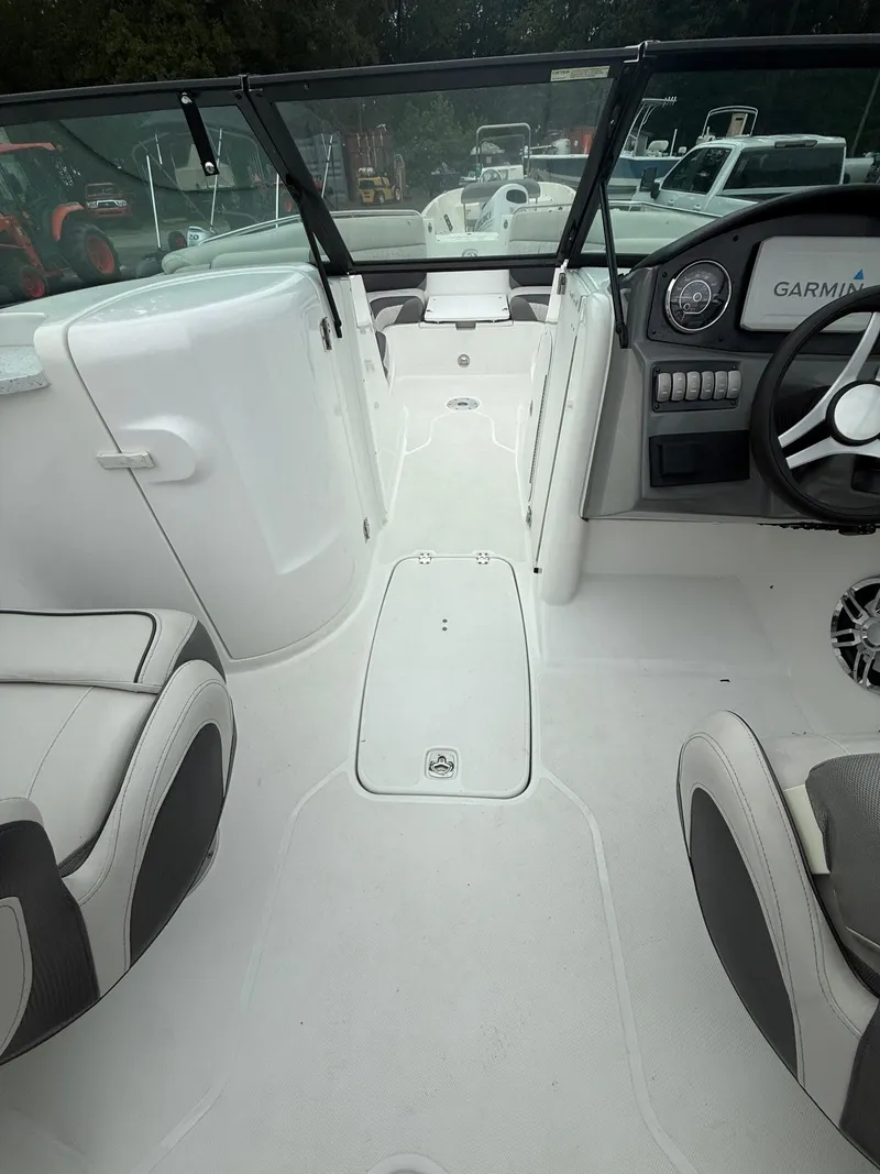 Slide: The Image of Interior of a 2022 Hurricane SD 2486 boat, featuring seating and a steering console. - 28