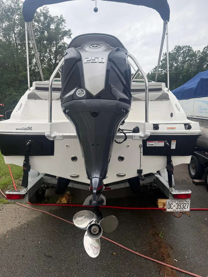 Slide: The Image of 2022 Hurricane SD 2486 boat with powerful outboard motor, parked on a trailer. - 31