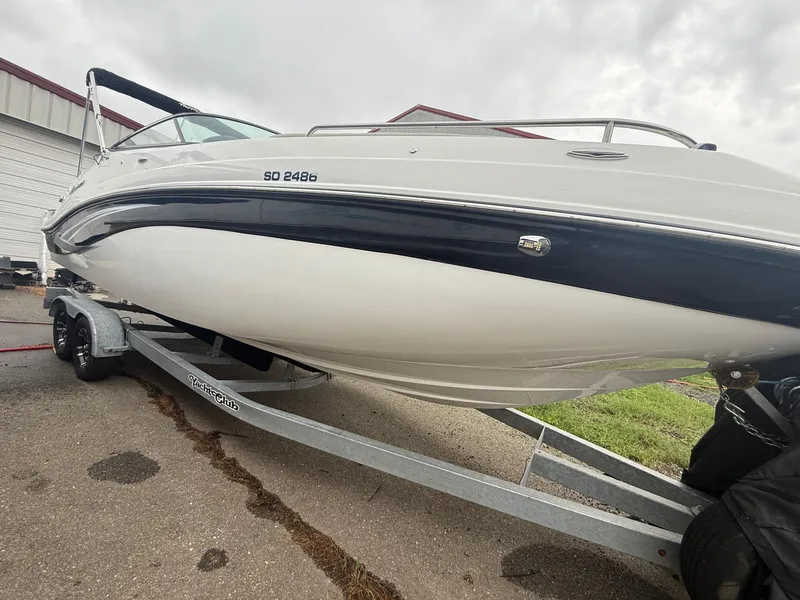 Slide: The Image of 2022 Hurricane SD 2486 boat on trailer, parked outdoors, overcast sky. - 34